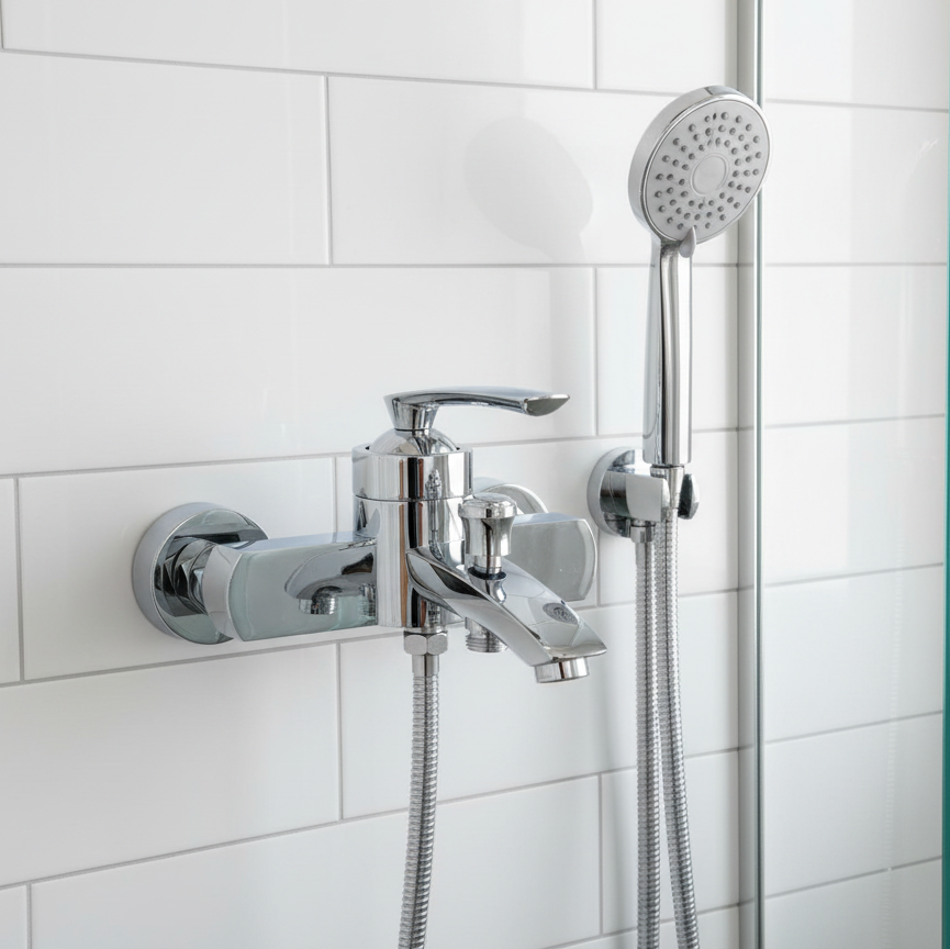 Modern cylindrical shower mixer in glass enclosure