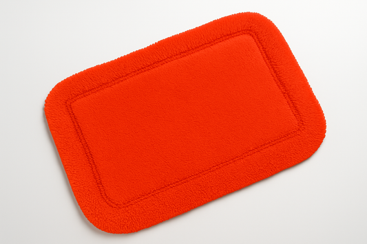 Flame red rectangular bath mat positioned at an angle
